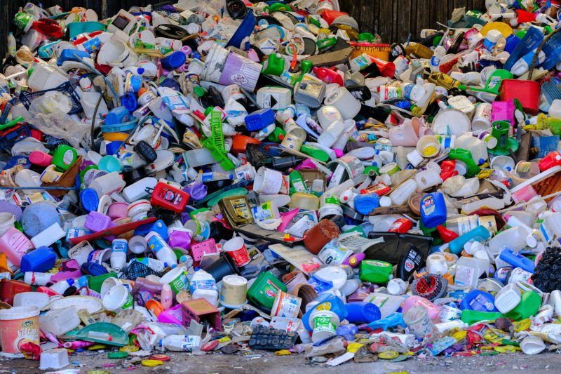 Massive colorful collection of used plastic bottles and containers in a recycling center.